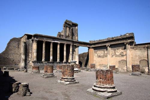 What building was located at the southwest corner of the forum and what two purposes did it serve fo