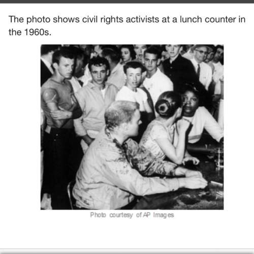 The photo shows civil rights activists at a lunch counter in the 1960s. the photo