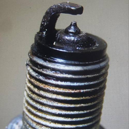 The new spark plug shows in the photograph above has been fouled which of the following is the most