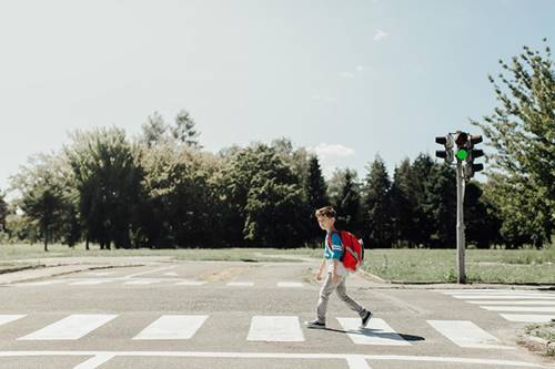 Does the child in the crosswalk have the right of way? Explain why or why not.