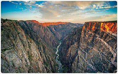 The rock in Black Canyon, shown below, has bands of light and dark. These bands have different mine