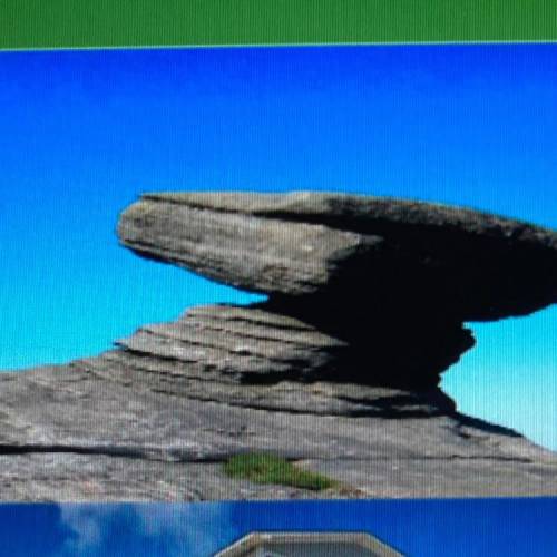 In the photo of the wind sculpture; why are there bigger rocks

balancing on smaller rocks? How do